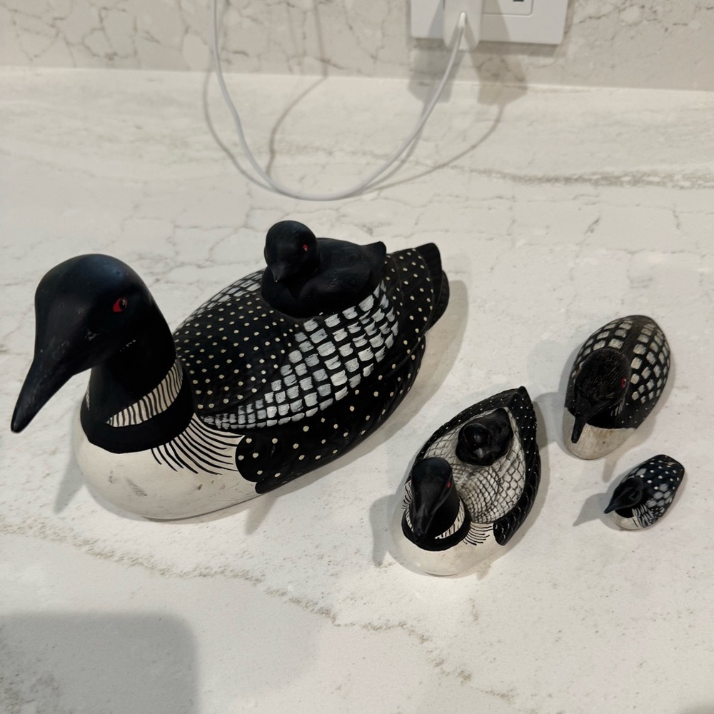 Hand carved ceramic/wooden figurine of a Common Loon carrying family